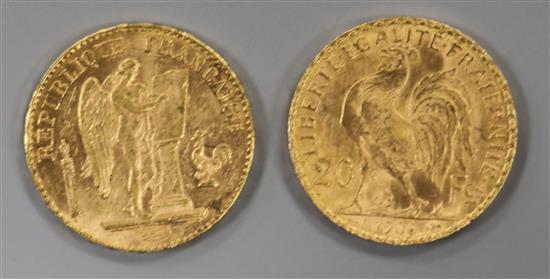 An 1897 French Guardian Angel 20 franc gold coin and a similar 1906 Rooster coin.